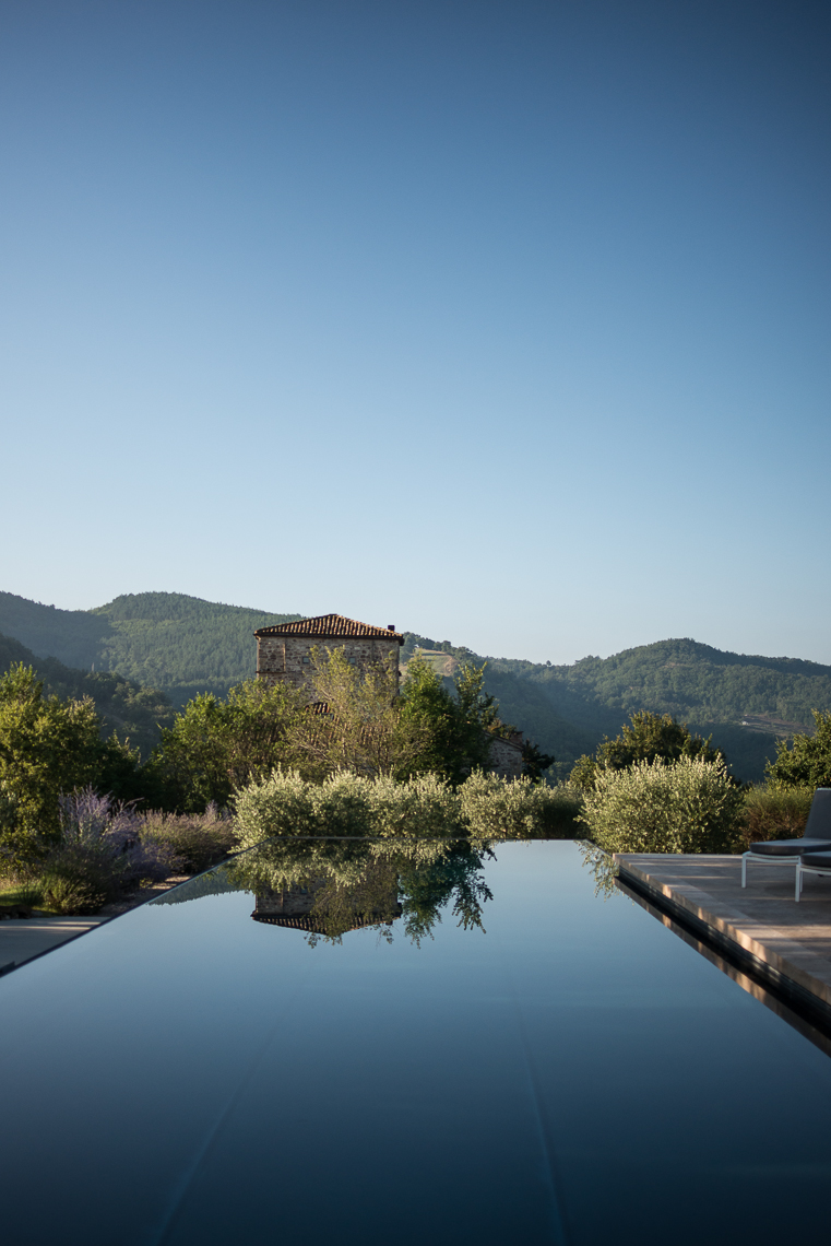 Infinity pool at an Italian villa with lush greenery